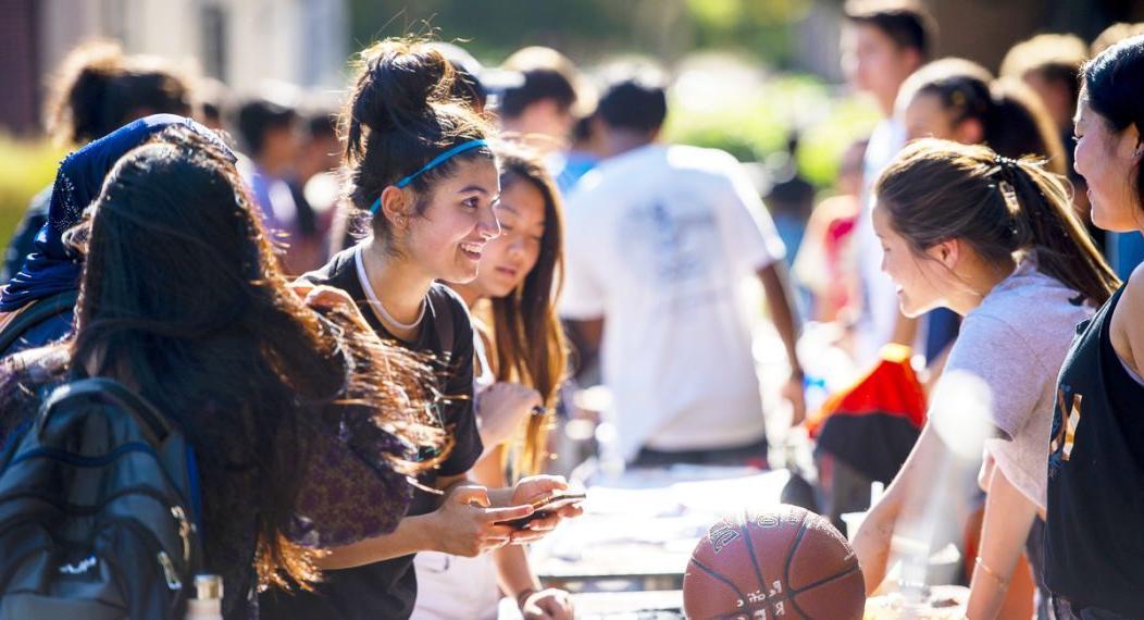 students learn about clubs and organizations at club fair